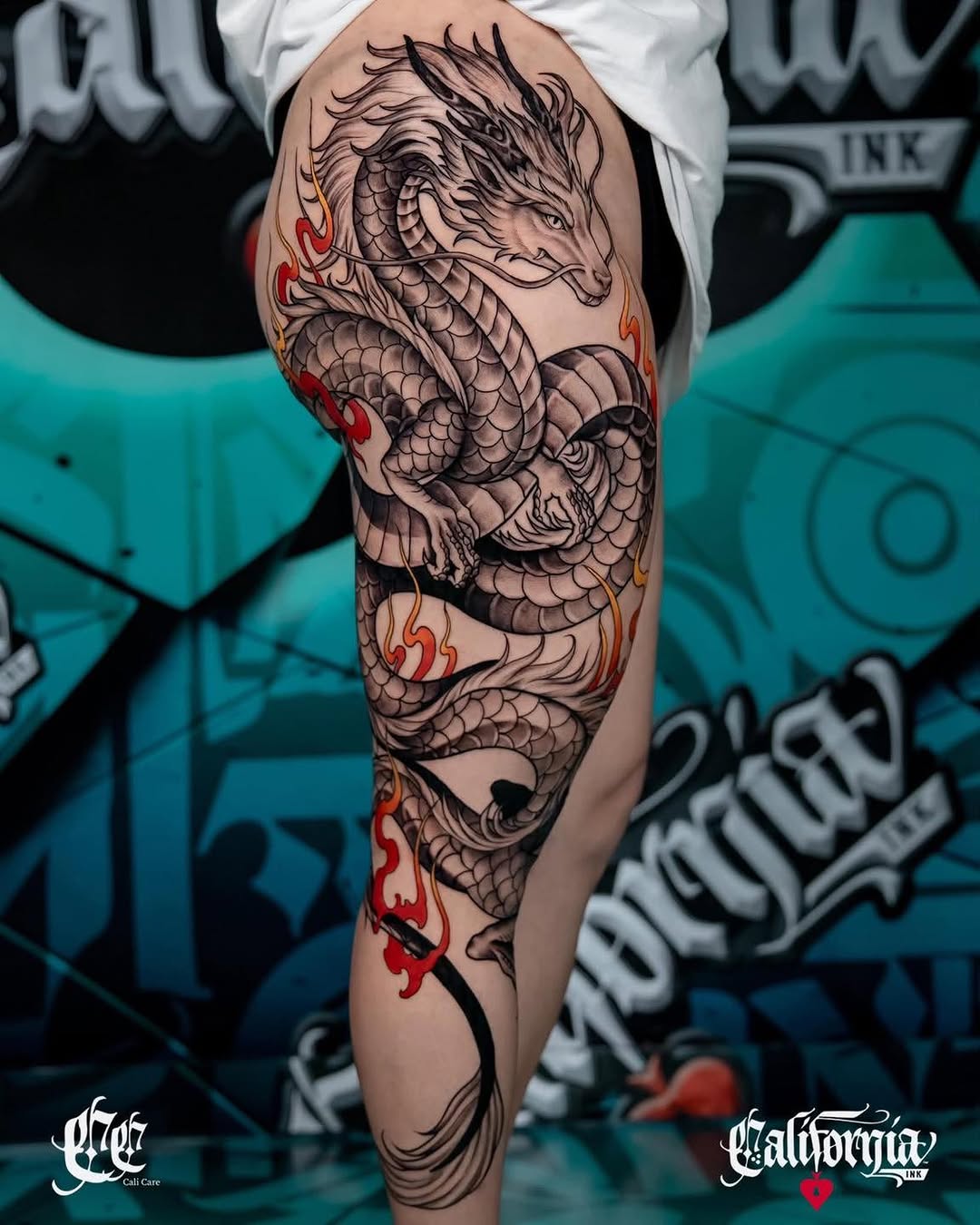 Japanese-inspired dragon leg tattoo with flowing black and grey detail and striking red accents.
World-class artists | custom designs | walk-ins welc